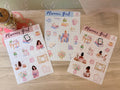 Three sheets of 'Planner Girl' stickers on a wooden surface.
