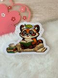 A Tanuki Situation Die-cut Sticker - Reading in Chair