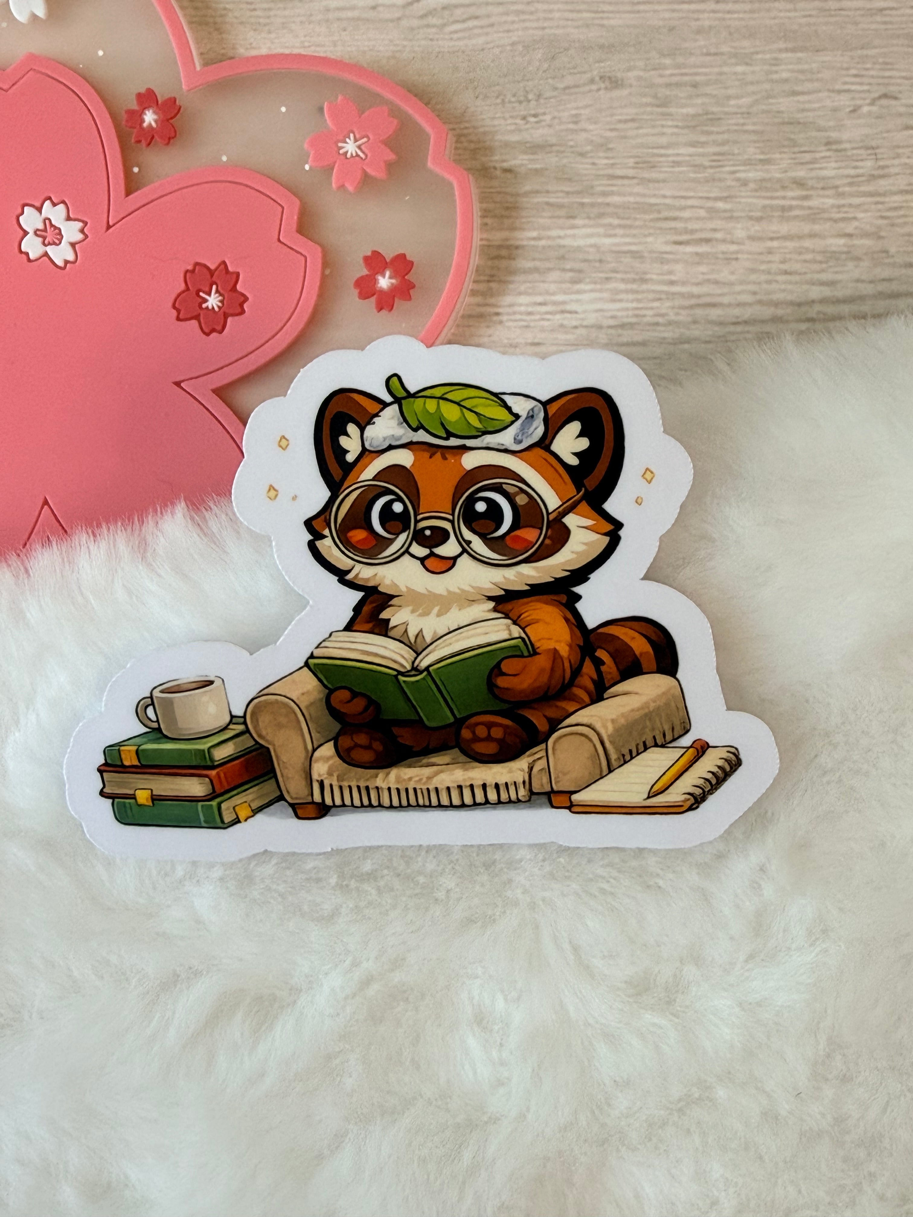 A Tanuki Situation Die-cut Sticker - Reading in Chair