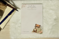 Notepad with a raccoon illustration and motivational quote on a textured surface